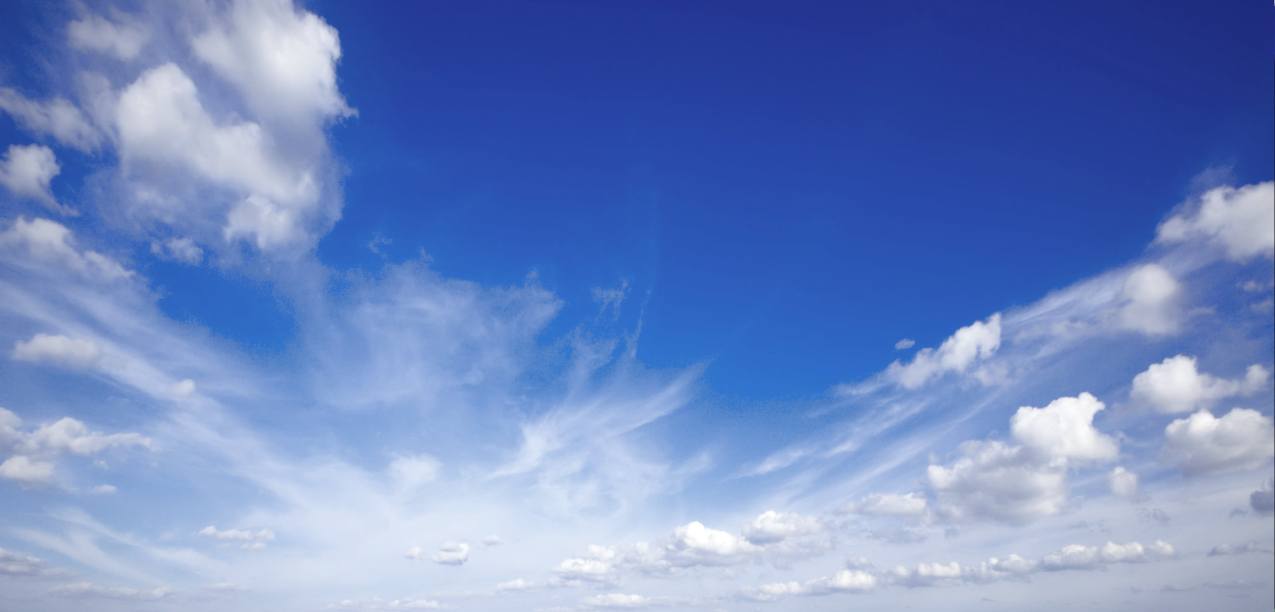 A blue sky with some clouds in the background